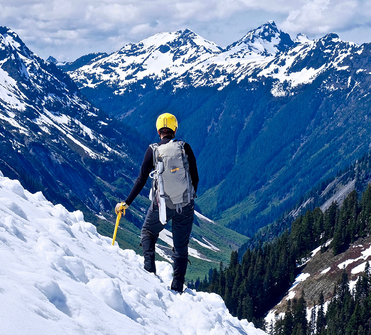 Image of a trailblazer climbing a mountain, embodying Northern Pacific's commitment to helping trailblazing clients in Houston, Seattle, Bellevue, The Woodlands and across the US live exponentially through comprehensive financial advisor and wealth management services in legacy, retirement, and estate planning, investment and asset management, wealth and tax planning, and business valuation, catering to entrepreneurs, executives, oil and gas, technology, health care and physicians, and highly compensated professionals.
