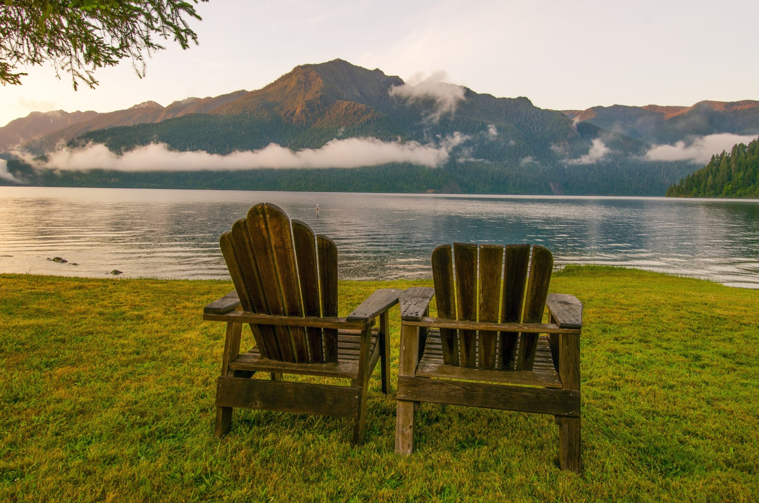 Parallel chairs overlooking a peaceful landscape in the Pacific Northwest, representing the strategic alignment and balance of parallel SLATs in estate tax planning. This visual ties directly to the concept of parallel SLATs by illustrating how two entities (the chairs, or the trusts) can remain distinct yet aligned, offering a clear metaphor for the estate planning strategy.